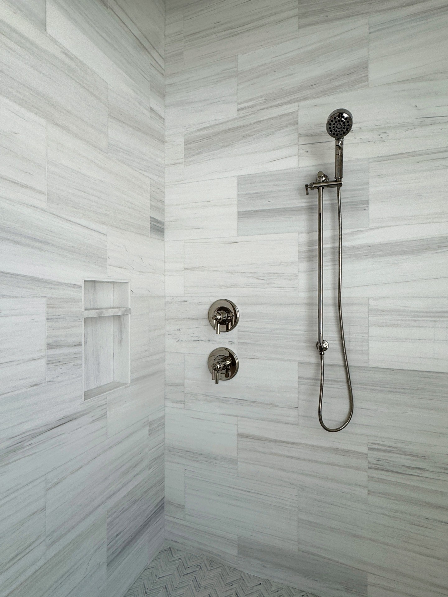 The master shower is designed with both style and function in mind. Clean lines, timeless tilework, and thoughtful details are hallmarks of every Huff Home in Watersound Origins®. It’s the kind of space that makes everyday living feel like a retreat.  #HuffHomes #WatersoundOrigins