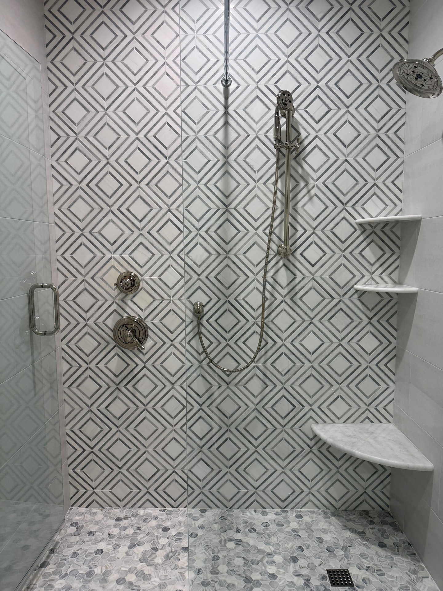 This custom tile shower brings pattern, texture, and craftsmanship together in the best way. A beautiful statement space designed for everyday luxury in @watersoundorigins.